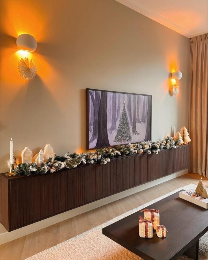 Dark walnut BESTÅ unit with festive decor from @huisjeinhetpark modern living room IKEA inspired console setup.