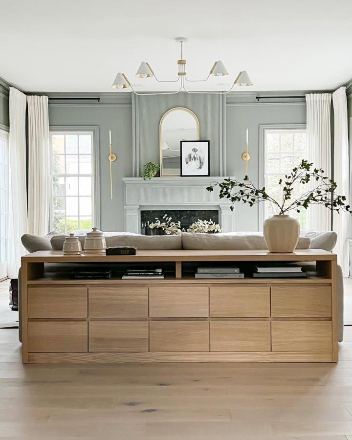 Oak-finished sofa table with storage drawers from @champagne.chaos styled in neutral living room inspired by Pottery Barn designs.