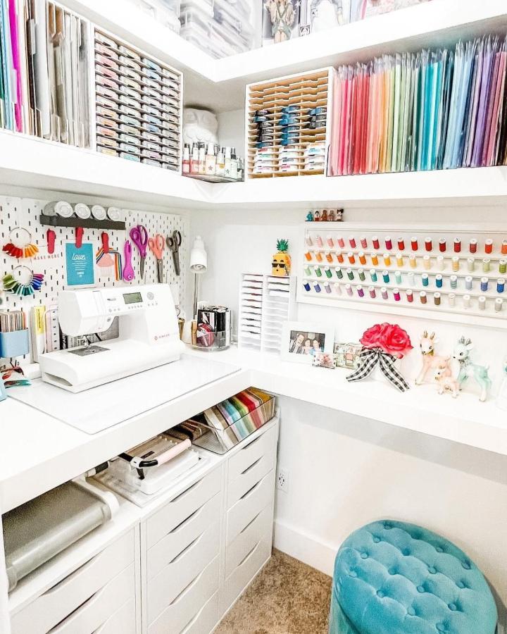 Bright organized sewing nook with Ikea Alex drawers and Skadis pegboards from @laura_evangeline featuring neat thread storage and vibrant craft supplies ikea sewing table ideas.
