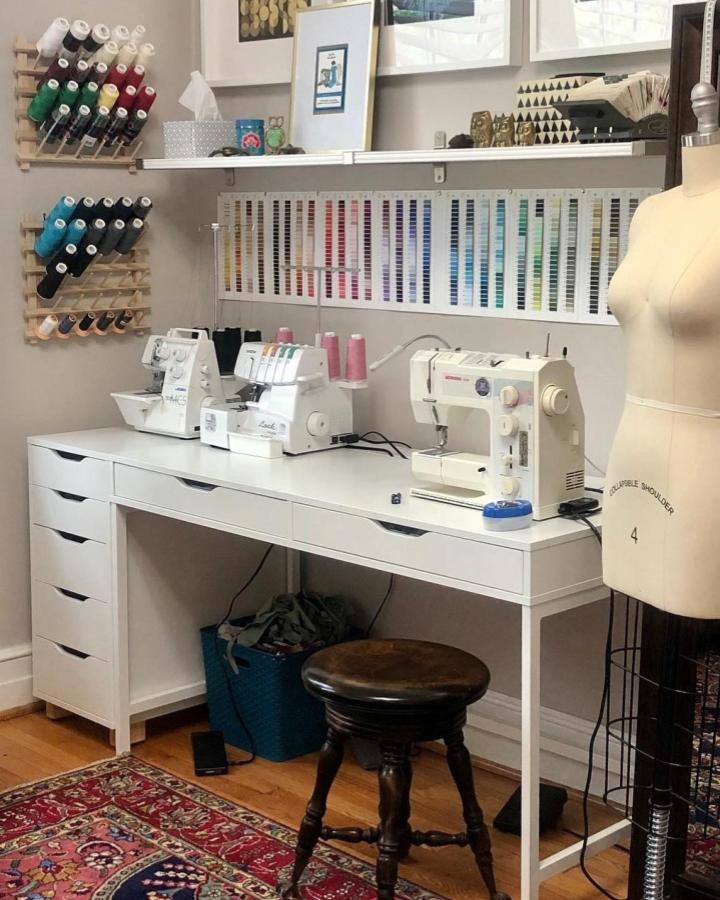 White Ikea Alex drawer unit sewing station from @perpetual_wip with thread racks and color chart for organized crafting.