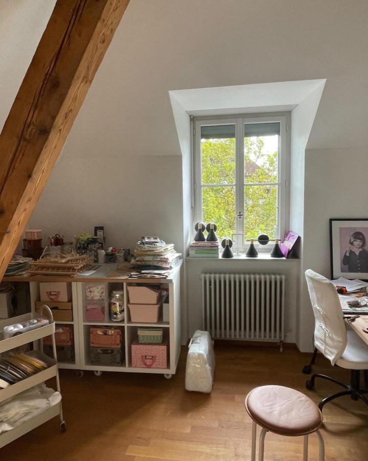 White and natural wood sewing nook with Ikea Kallax storage and rolling cart by @tatia.studio. Cozy attic workspace with neat organization.