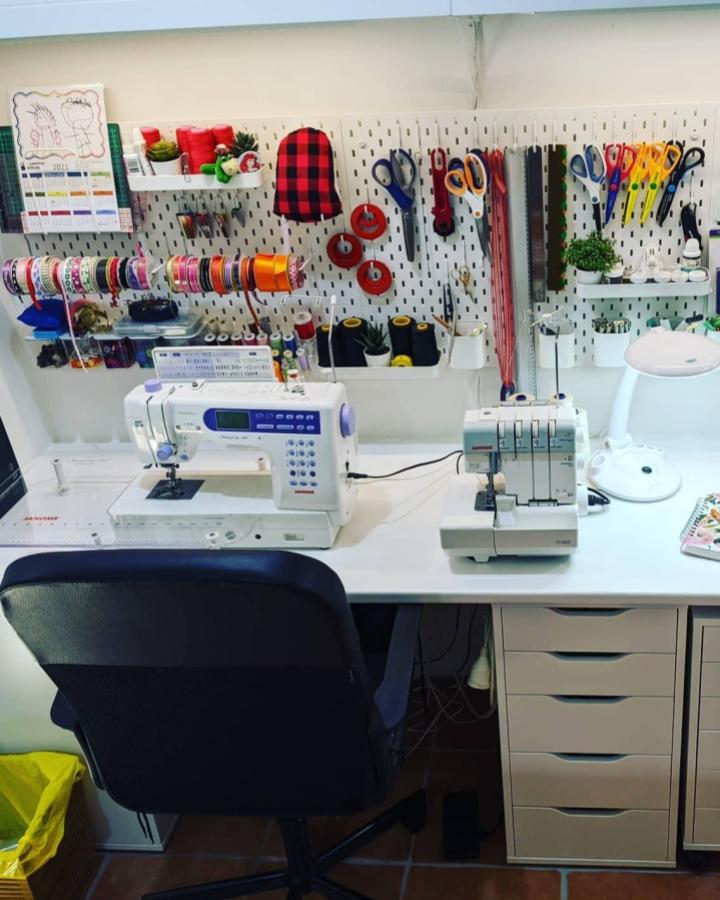 White Skådis pegboard craft wall with scissors ribbons and IKEA Alex drawers from @seamscapes bright and organized sewing space setup