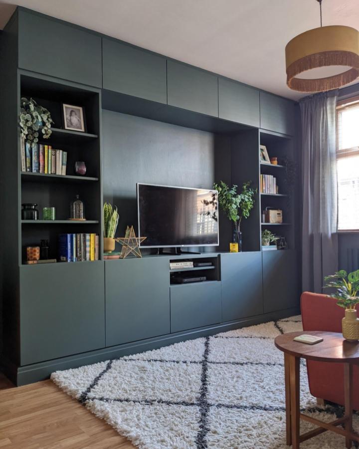 Dark green built in IKEA Besta entertainment center by @nospacelikehome showing clever ikea small living room hacks with stylish storage and display.