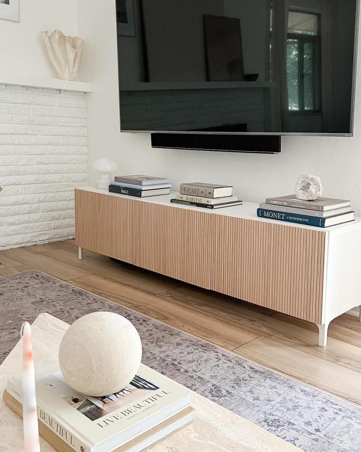 Light wood slatted front Ikea Besta media console from @thrill_of_thrift in a cozy compact living room setting.