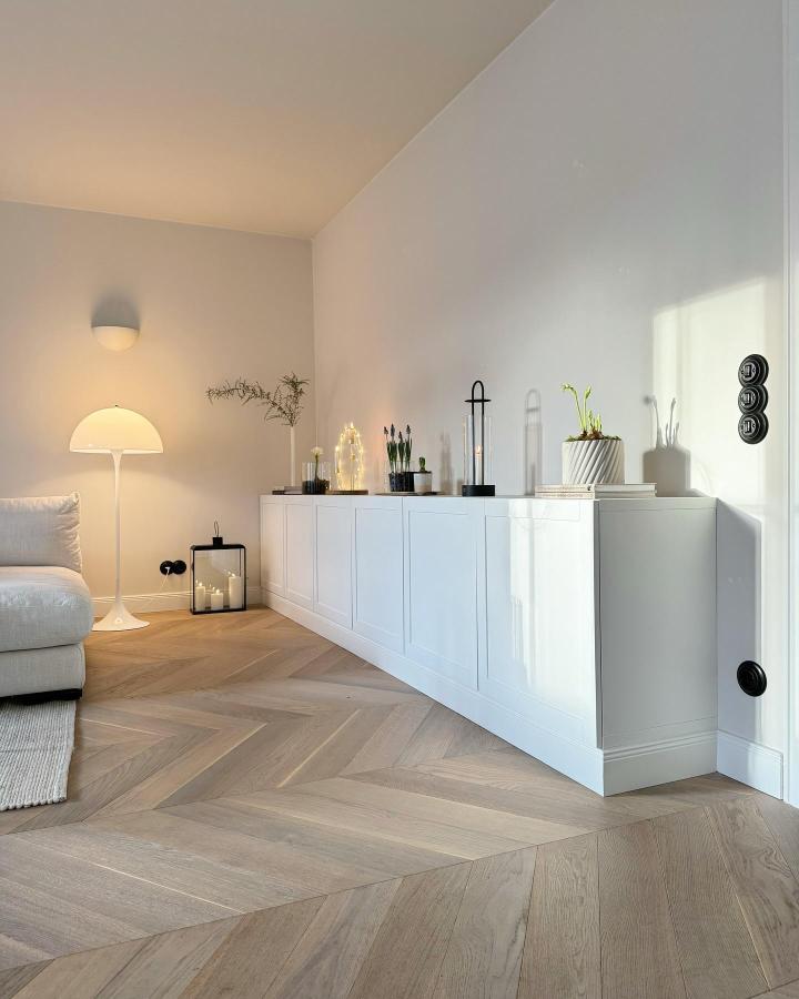 White sleek Besta sideboard with modern decor and lighting in a cozy living room by @butiksofie smart storage solution for compact living spaces.
