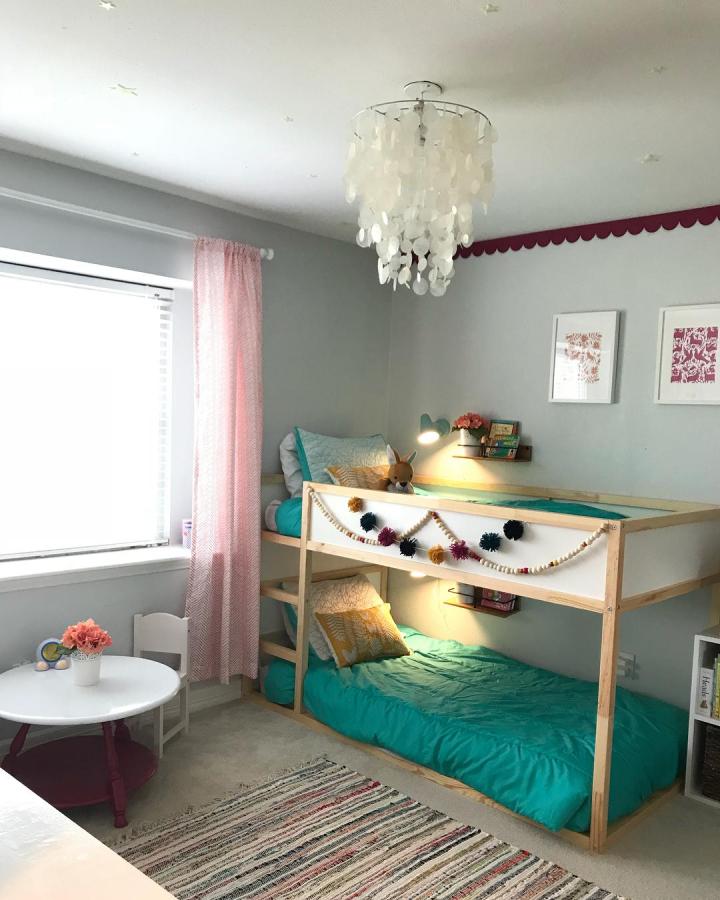 Teal natural-wood bunk bed from @oakstorydesign. This nook features best accessories for ikea kura beds and pom-pom garland.