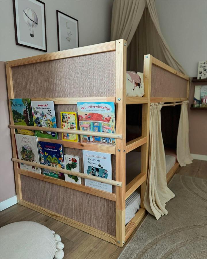 Natural pine KURA bed from @interiorbypam. Front book display and cream under-bed curtains create a cozy reading nook.