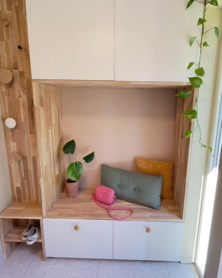 Natural wood and white entryway from @charlottesdiyhome. IKEA Besta built in ideas with bench nook, shoe storage, and plants