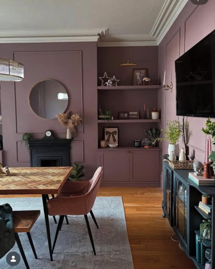 Dusty plum built-in media wall from @edwardian_property_parade. Framed shelves and concealed Besta storage complement the period room.