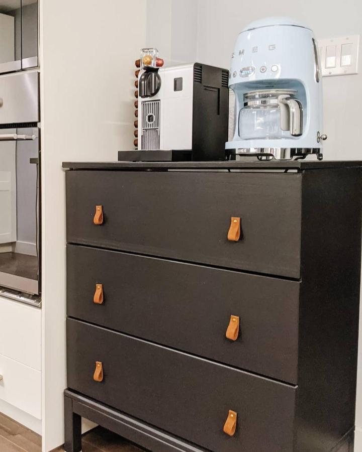 Black IKEA TARVA coffee station from @thebuildingontop. Cognac leather pulls and white appliances top the dresser.