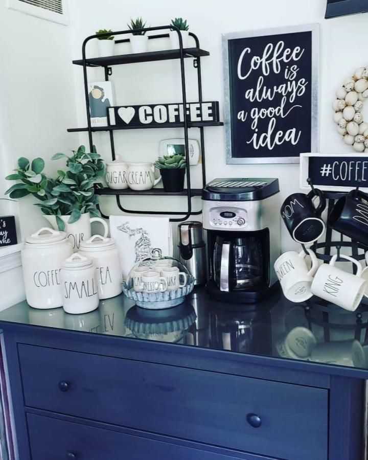 Navy IKEA HEMNES coffee station from @geebejammin. Black metal shelf, white canisters, plants, and compact coffee maker.