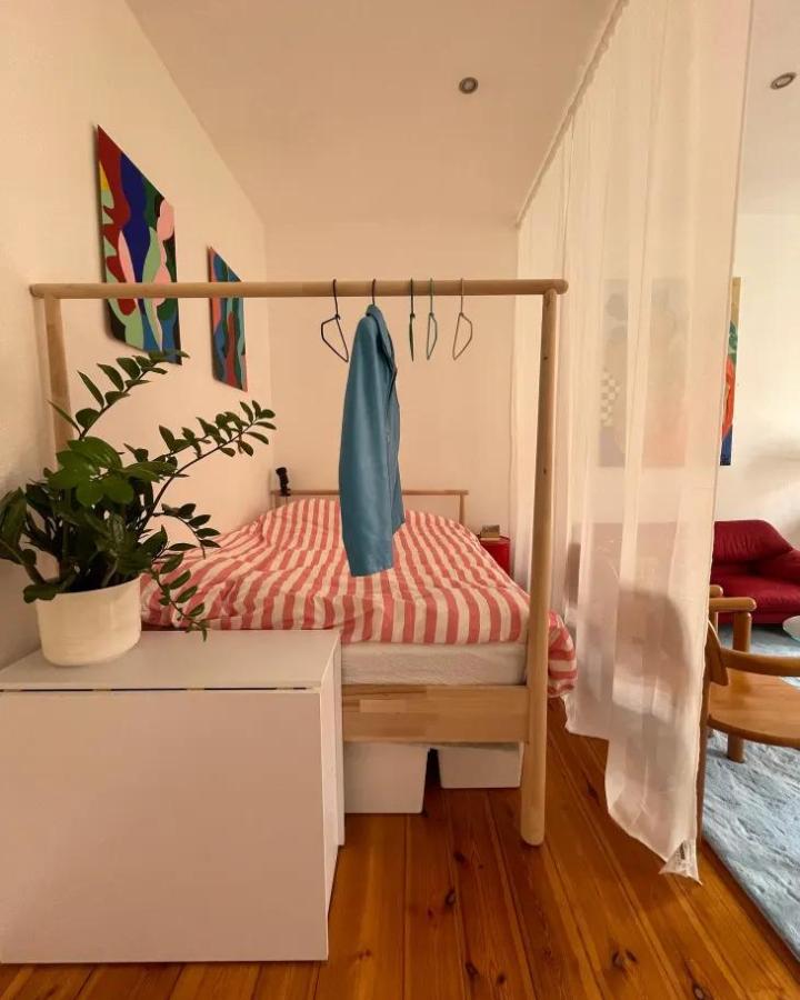Airy white bedroom with ikea curtain room divider ideas from apartmetn therapy. ROSENROBINIA sheer curtain separates the bed.
