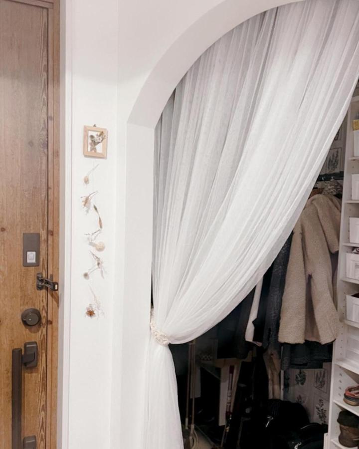 White sheer curtain closet divider from @omochi4126. Arched opening with gathered tieback.