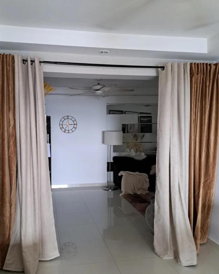Cream and caramel layered living room divider from @scandistylzsingapore. SANELA curtains hang from a black rod.