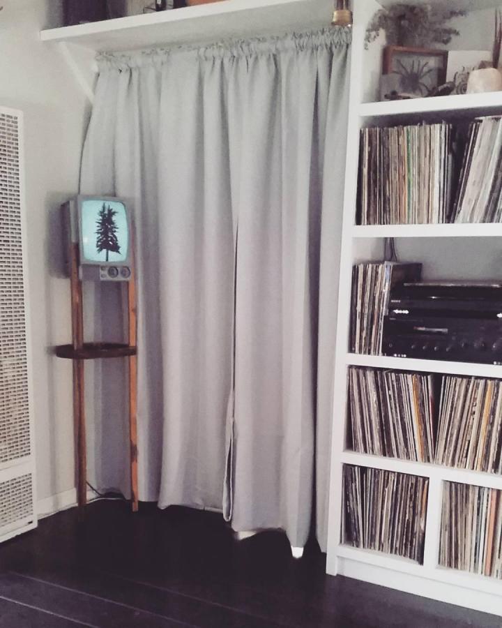 Soft gray living room curtain divider from @mastersonmade. VILBORG curtains illustrate ikea curtain room divider ideas beside white shelving.