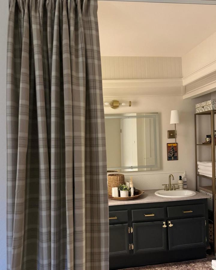 Gray plaid bathroom curtain from @maxwell.haus.design. HรGGVECKMAL fabric creates ikea curtain room divider ideas.