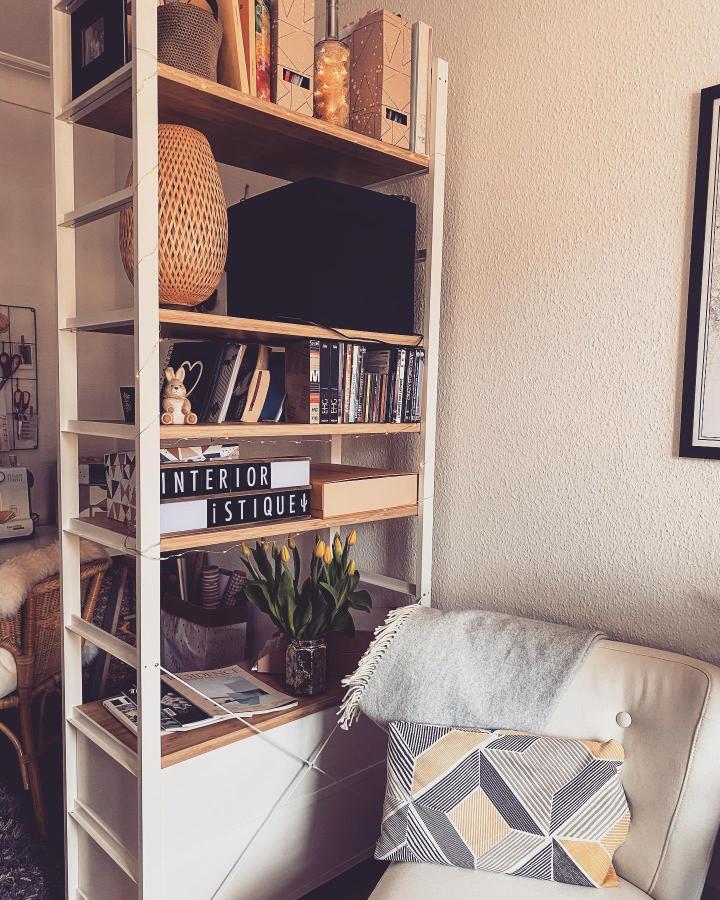 White-and-warm-wood ikea elvarli room divider ideas from @interioristique. Open shelving separates a cozy seating area.