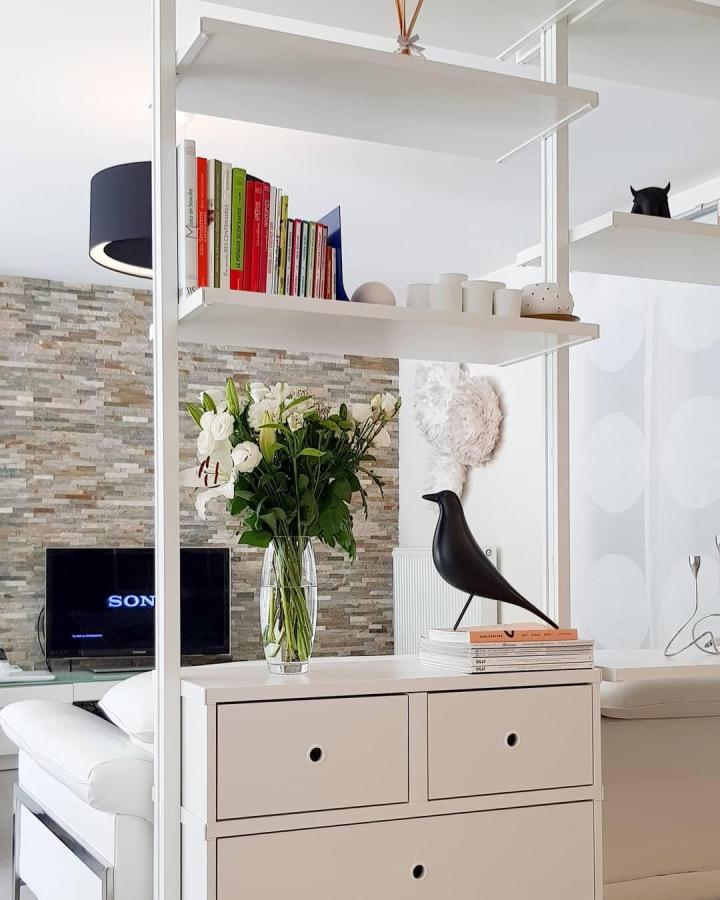White open-shelf living room divider from @my_.happy_.place. This showcases ikea elvarli room divider ideas with pale beige drawers.