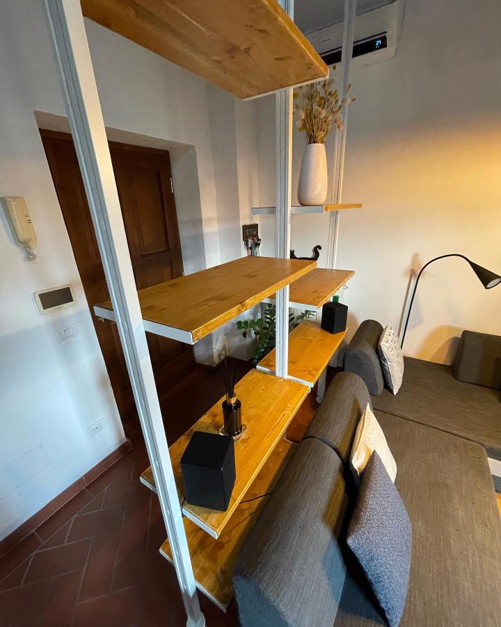Warm wood and white Elvarli room divider from @fabrizioreed. Open shelving separates a gray sofa from the entry.