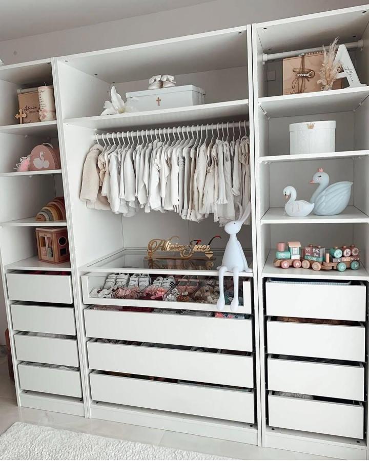Soft white PAX nursery wardrobe from @bercin_. Calm ikea pax nursery ideas with hanging baby clothes and drawers.