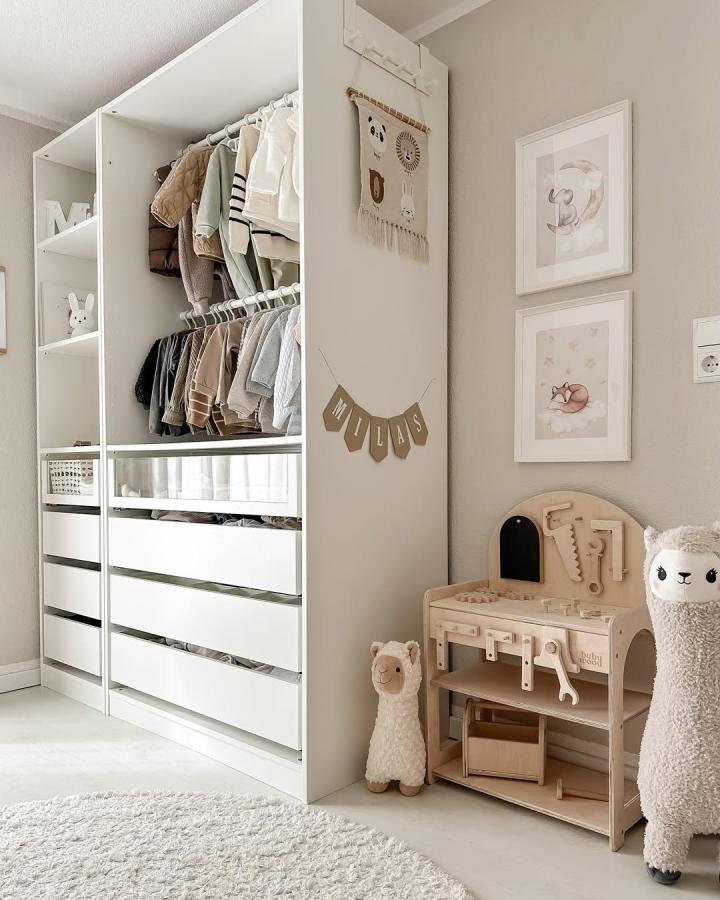 Soft neutral PAX wardrobe from @hausnummereinszwei featuring ikea pax nursery ideas, open shelves and drawers.