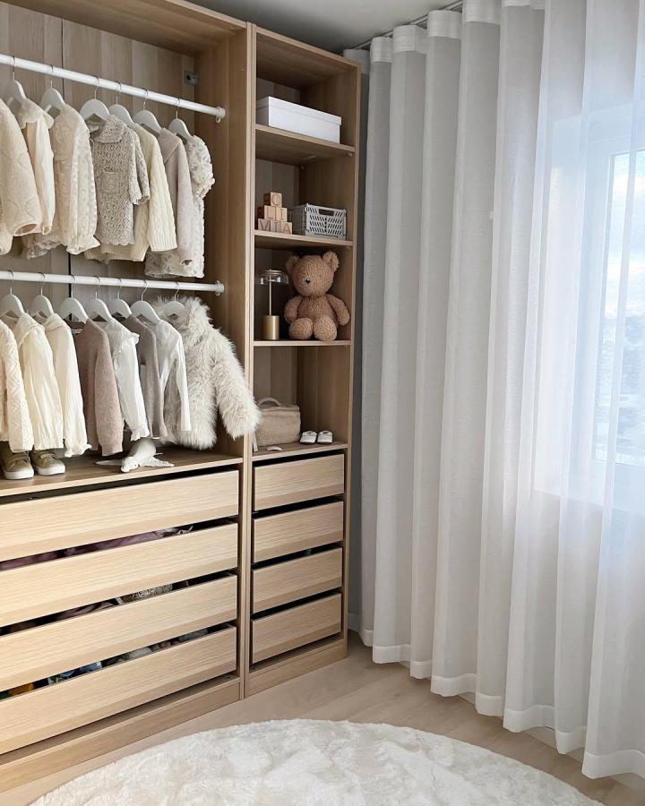 Warm Oak IKEA PAX Nursery Wardrobe from @fregnate. Open shelves, baby clothes, and soft curtains.