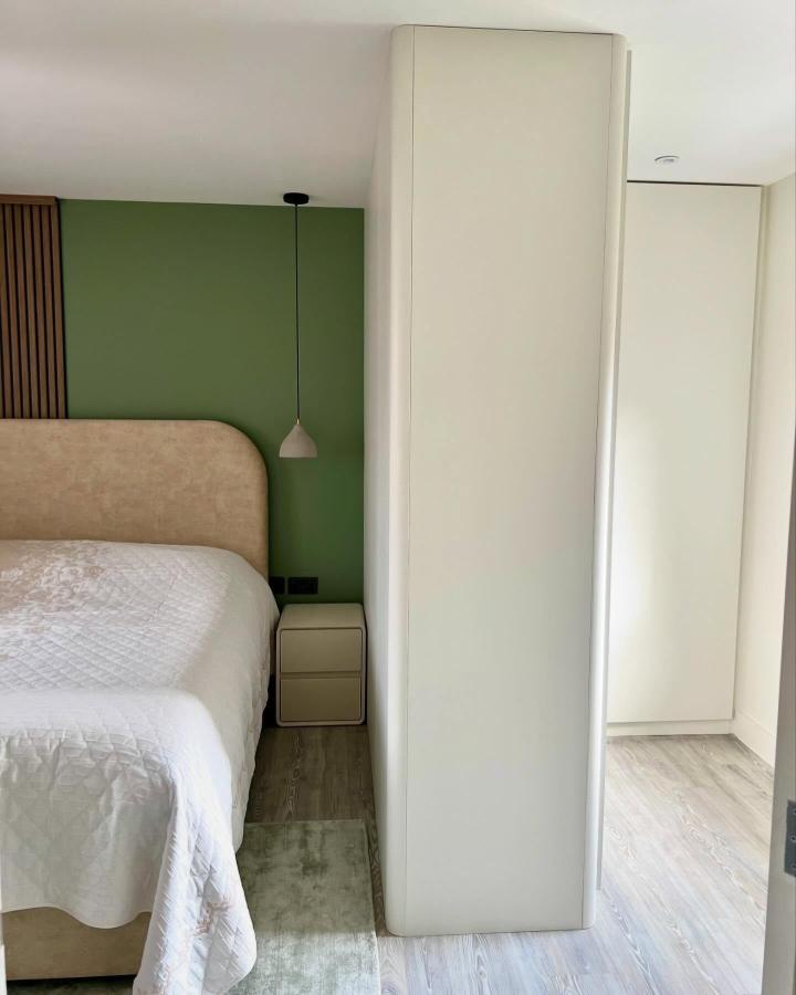 Warm white bedroom divider from @the_pax_man. Tall PAX cabinetry separates the bed from the hallway.