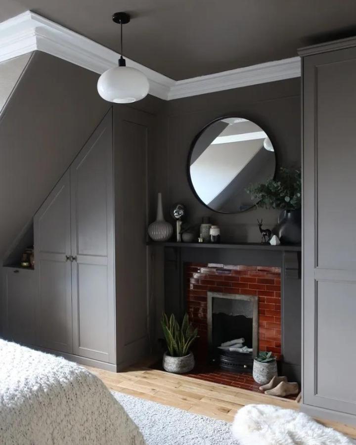 Charcoal built-in bedroom wardrobes from design sixty nine. ikea pax small bedroom ideas frame a fireplace under sloped ceiling.