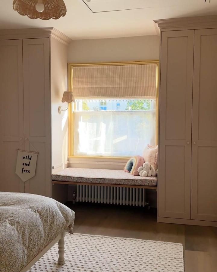 Warm Taupe PAX Bedroom from @1894home. Built-in window seat between paneled wardrobes.