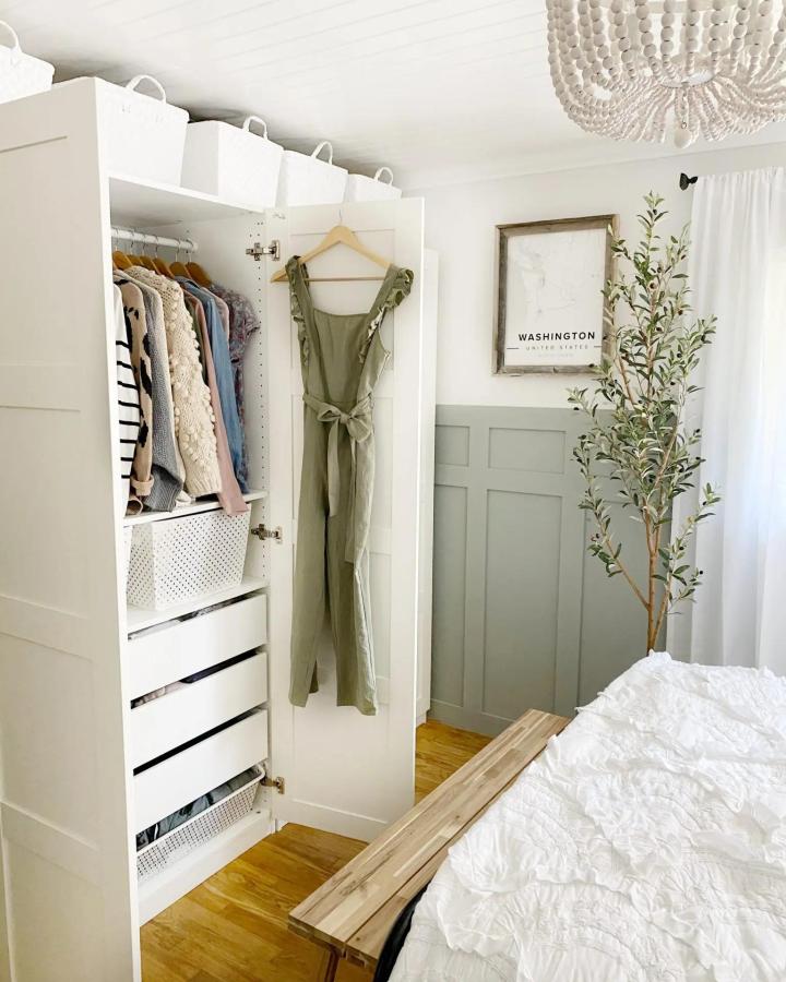 White PAX wardrobe from dreaming of home making. Compact bedroom storage with drawers, baskets, and hanging clothes.