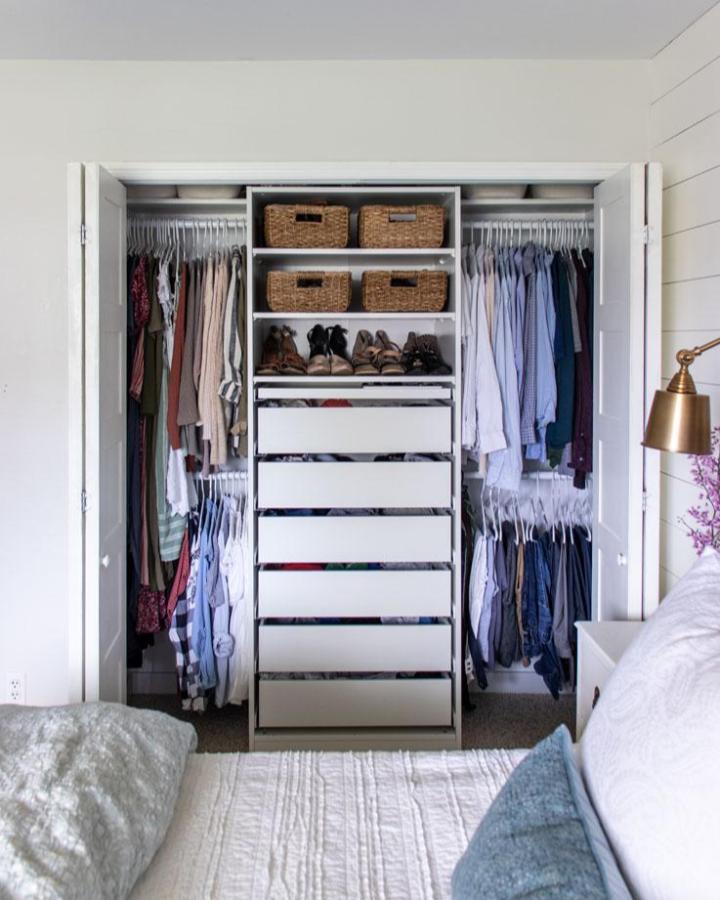 White built-in PAX closet from shades of blue interiors. ikea pax small bedroom ideas with drawers, baskets, shoes, and hanging clothes.