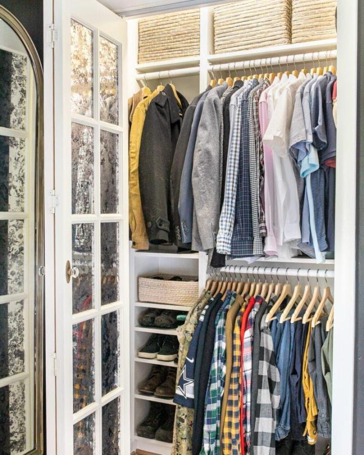White built-in closet from blesser house. ikea pax small bedroom ideas feature open rods, baskets, and glass doors.