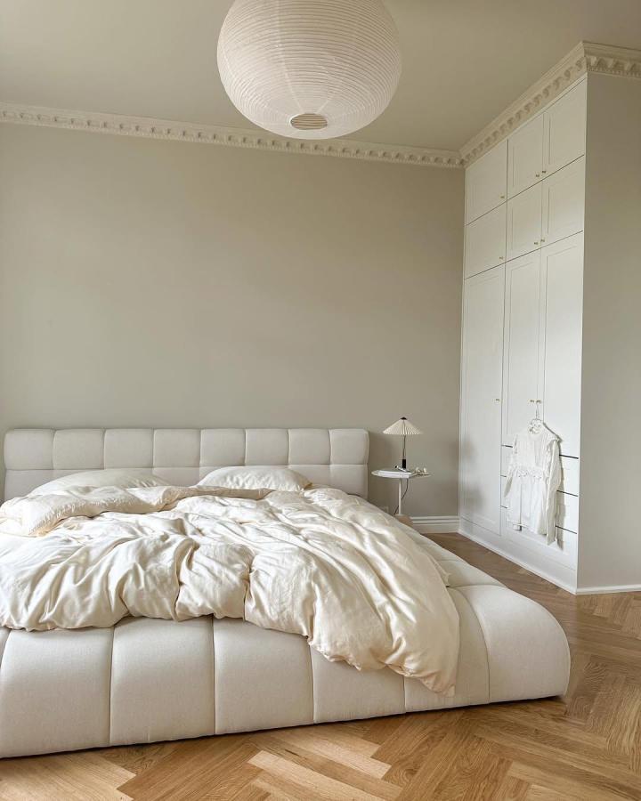 Cream built-in bedroom wardrobe from @katjanordkvist. Tall Platsa-style storage blends with classic molding.