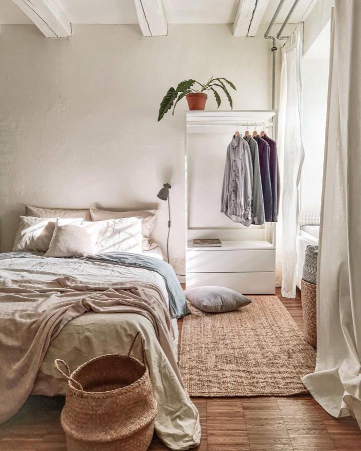 White open PLATSA wardrobe from @myhomeinswitzerland. Airy bedroom storage with drawers, hanging rail, and woven textures.