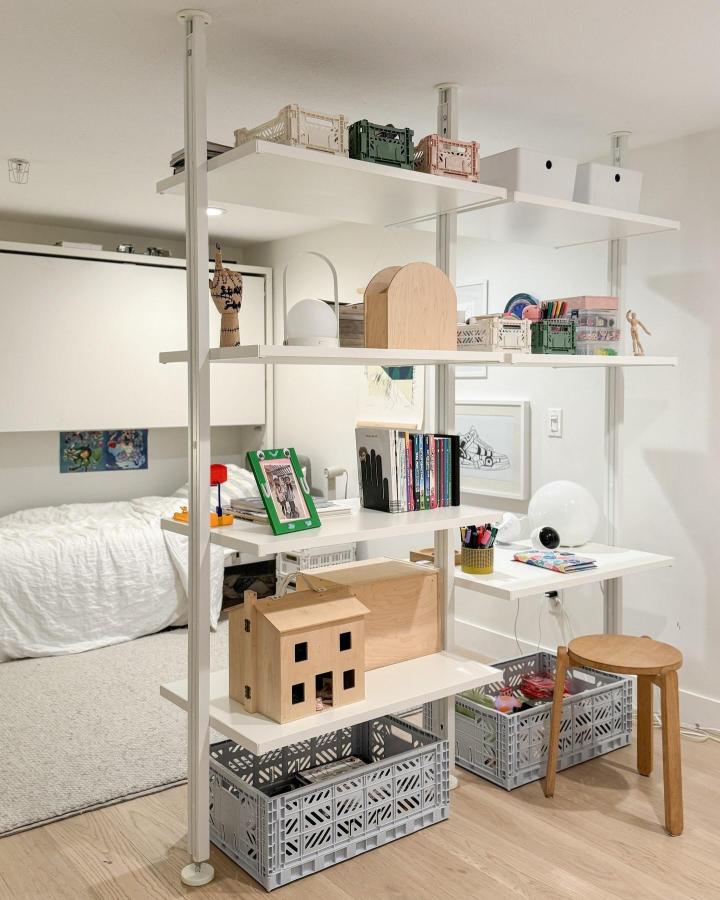 White ELVARLI shelving divider from @600sqftandababy. Separates a shared kids’ room with storage and desk space.