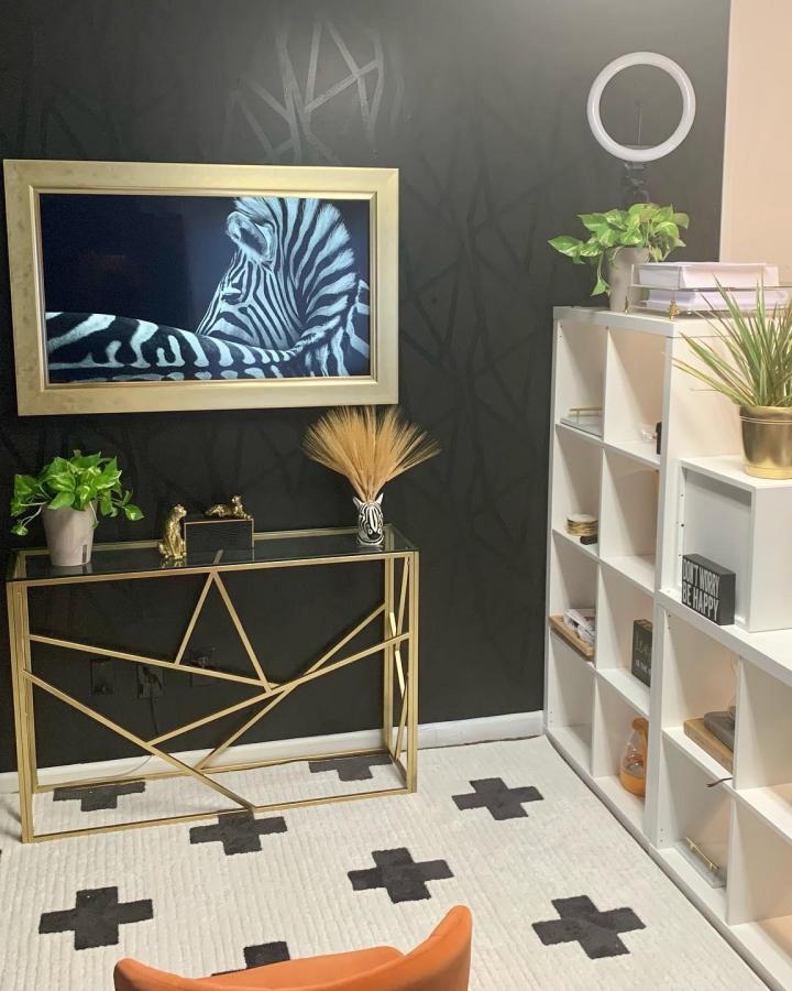 White KALLAX shelving room divider from @lifewithleeks. Open cubbies separate a stylish living area with greenery.