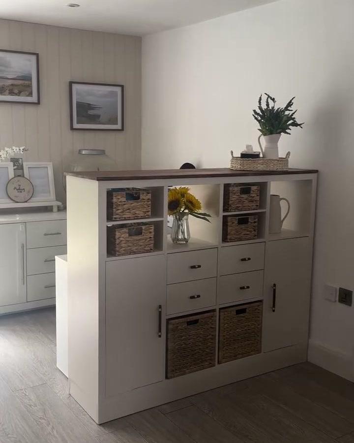 White KALLAX sewing area divider from @meehanscottage. Woven baskets and drawers organize a compact creative nook.