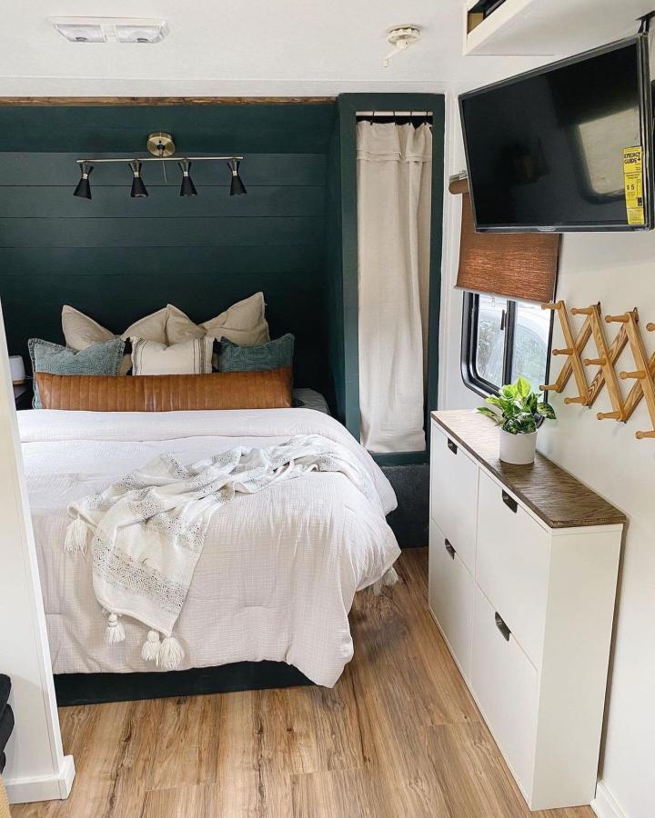 Deep teal and white small bedroom from @inspiredrvliving. Slim IKEA HEMNES storage keeps the cozy space organized.