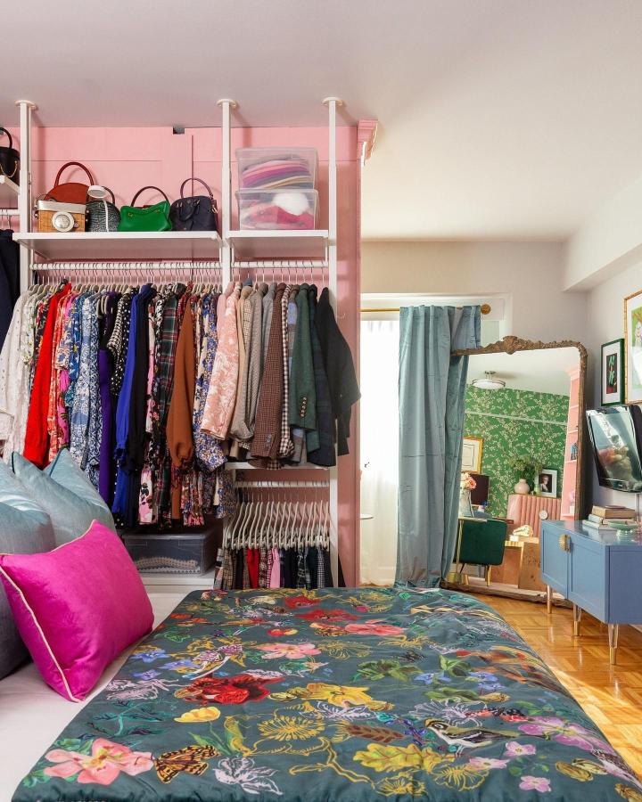 Pink IKEA ELVARLI wardrobe from @apartmenttherapy. Colorful ikea small bedroom hacks maximize vertical clothing storage beside a floral bed.