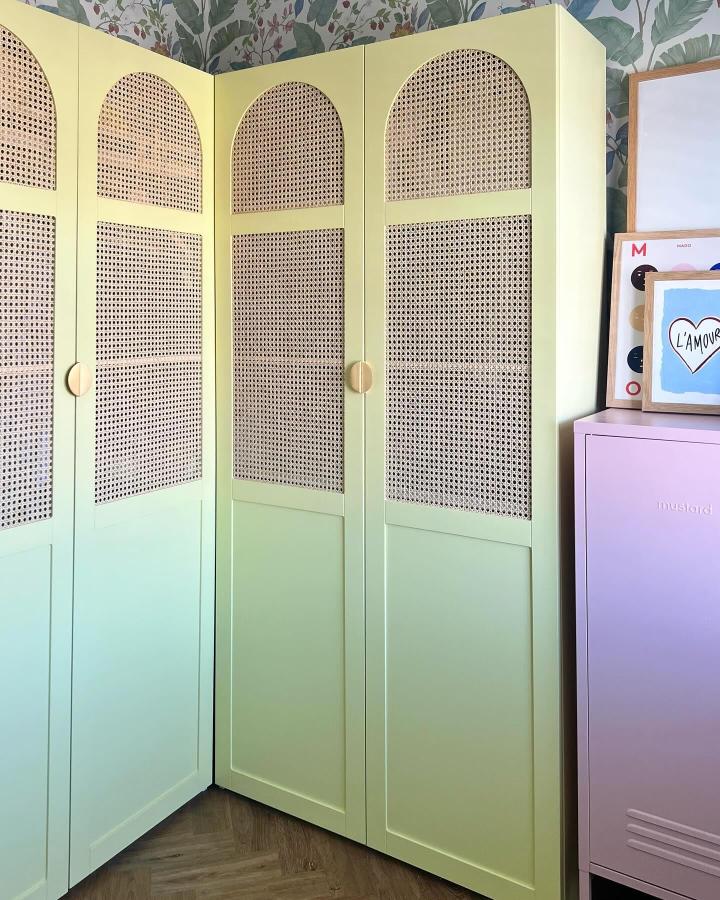 Pale pistachio green cane-front bedroom wardrobe from @homeofcharl. IKEA PAX storage turns a tight corner into a charming retreat.