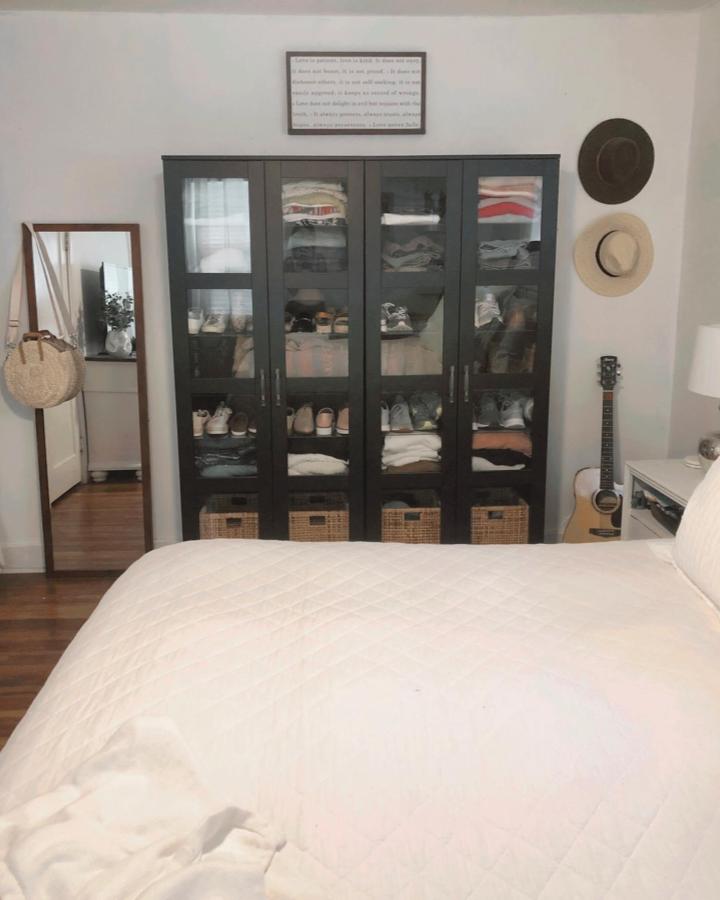 Charcoal IKEA BRIMNES bedroom storage from @danielle.knight_. Stylish ikea small bedroom hacks with glass doors.