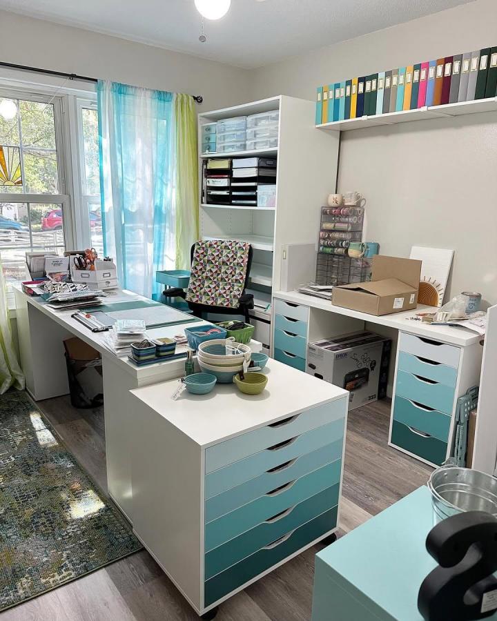 Turquoise and white craft room from @suebug63. IKEA drawer islands, shelves, and colorful organized supplies.