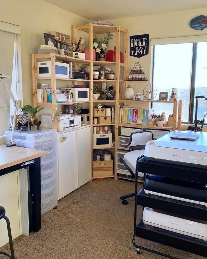 Natural Wood And White Craft Room From @lovebird_heartworks. Vertical shelves hold colorful supplies, printers, and organized drawers.