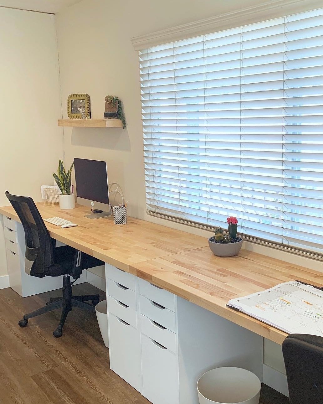 Warm butcher block desktop with white IKEA Alex drawers and an organized home office