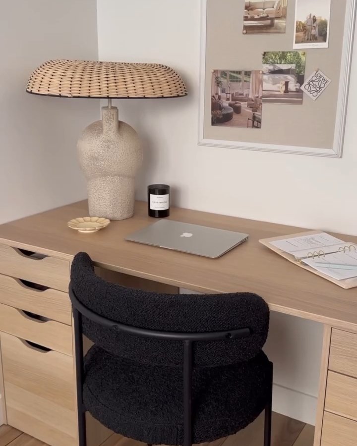 Warm wood desktop with IKEA ALEX drawers, textured lamp, laptop, planner, and black boucle chair