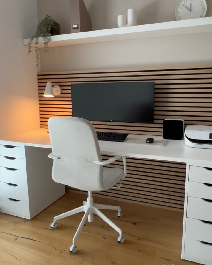 White IKEA ALEX desk with IKEA LACK slatted wall, monitor, drawers, and minimalist workspace styling