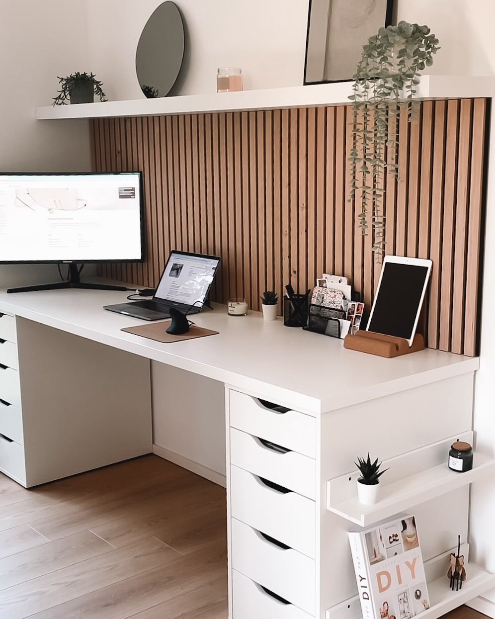 White IKEA LAGKAPTEN desktop with Alex drawers and a warm vertical slat wall