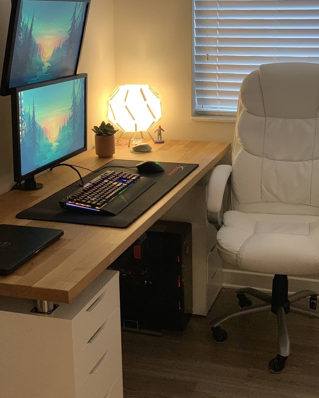 Warm IKEA ALEX gaming desk with KARLBY wood countertop, dual monitors, and ambient lighting