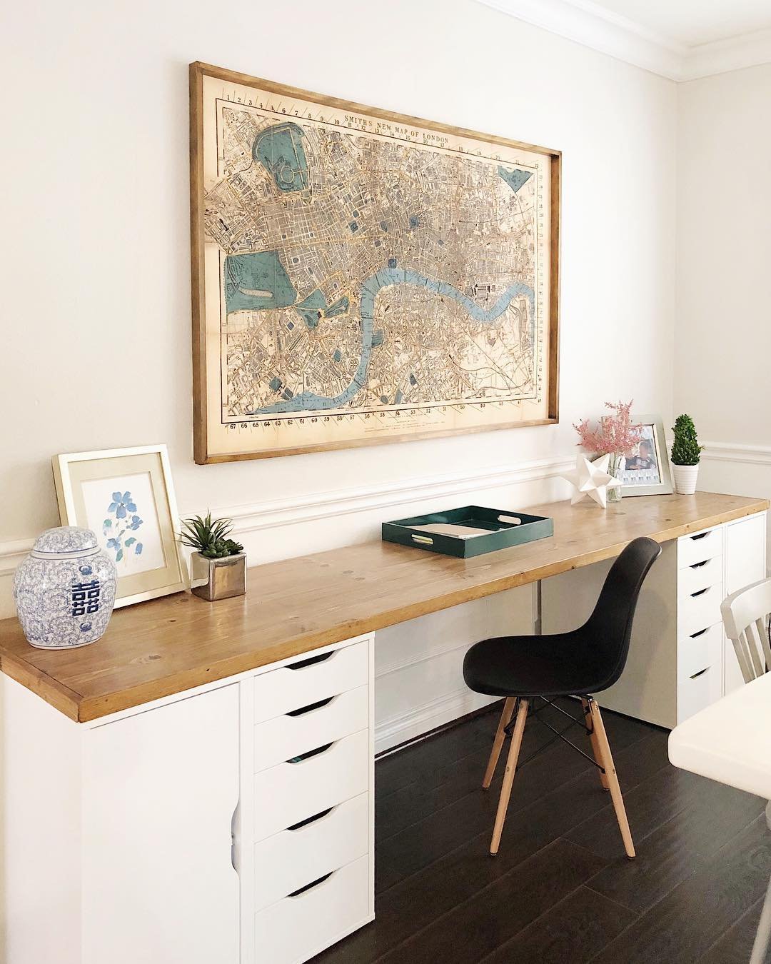 Warm pine desktop spanning white IKEA Alex drawer units in a bright home office