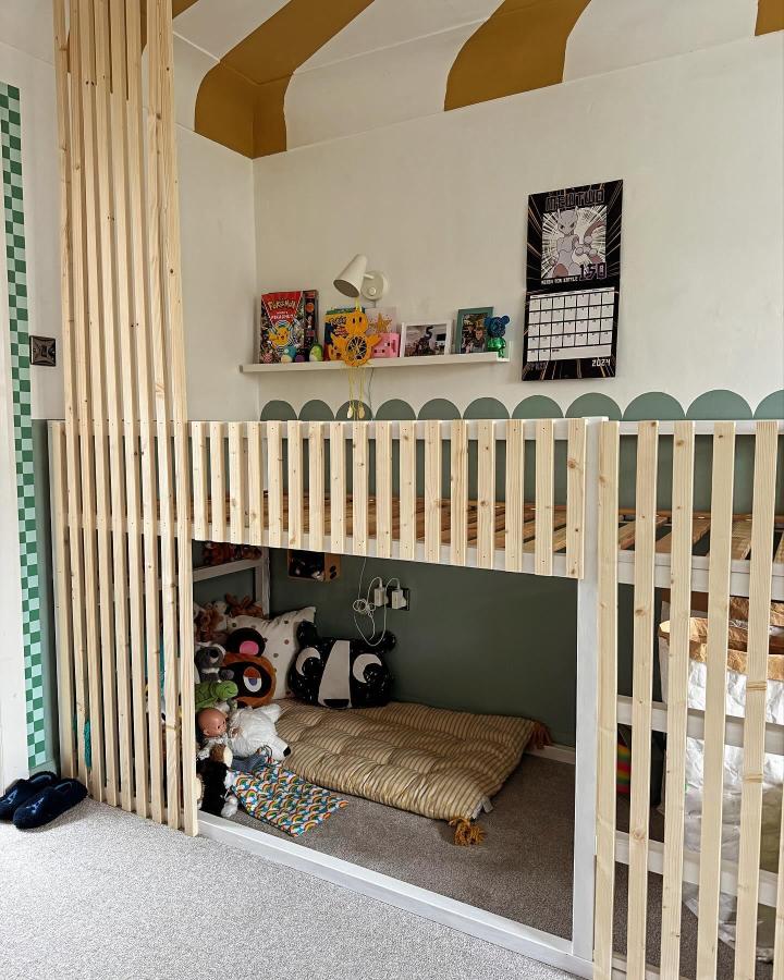 Natural pine slat loft bed from @woolton_interiors. Sage green play nook with striped ceiling.